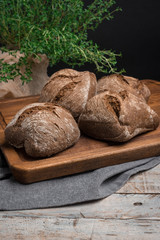 Homemade farm malt bread, malt flour on wooden table