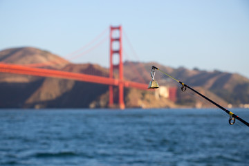 Close up of a fishing bell on a rod.