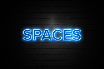 Spaces neon Sign on brickwall