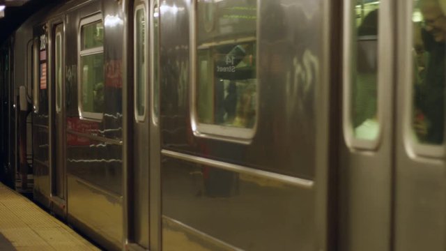 Slow motion of a moving train in a subway station in NYC