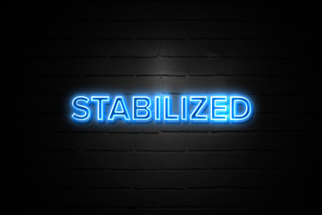 Stabilized neon Sign on brickwall