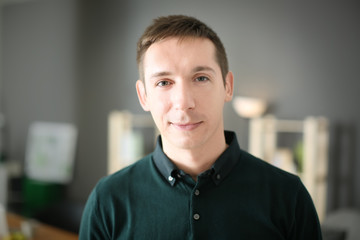 Portrait of young man in casual clothes indoors