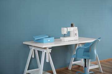 Sewing machine on table in tailor's workshop