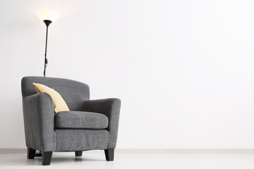 Elegant living room interior with comfortable armchair near wall