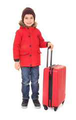 Cute little boy in warm clothing and luggage on white background. Ready for winter vacation