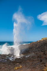 Waterhole with stream of water up in the air