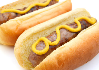Grilled Bratwurst with mustard on bun. Isolated.