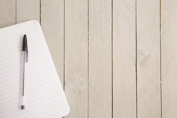 Blank Notebook Paper on a Wooden Table