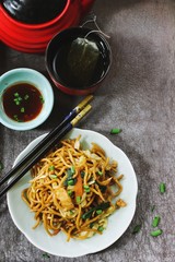 Homemade Chiinese Lo Mein Noodles served with green tea overhead view