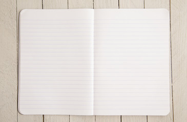 Blank Notebook Paper on a Wooden Table