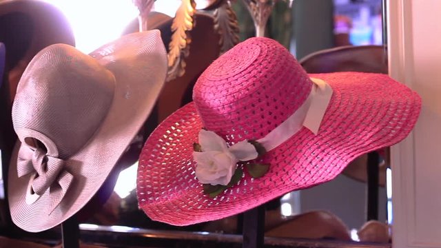 Tracking shot of decorative hats at a Kentucky Derby event.