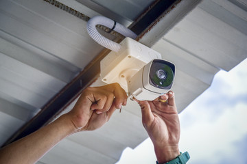 Technician installing CCTV camera system for security area  - Powered by Adobe