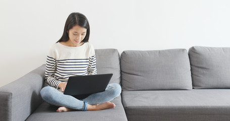 Woman working on laptop computer at home