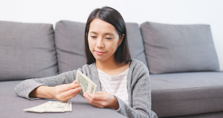 Obraz na płótnie Canvas Woman counting money banknote