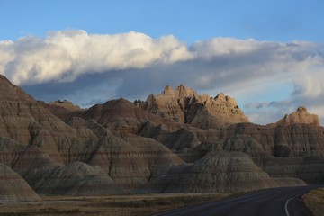 Clouds darkening over rough terrain near sunset ... Badlands