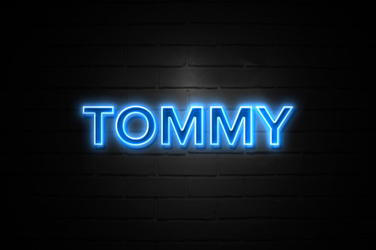 Tommy neon Sign on brickwall