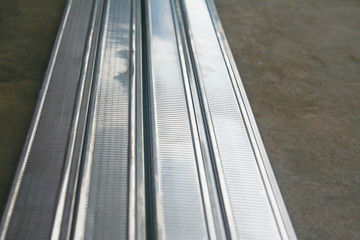 Obraz premium Aluminium rectangle shape with hollow are stacks on concrete floor.prepare for make ceiling.