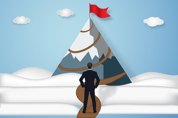 Fototapeta premium Businessman looking the red goal flag on peak mountain in the blue sky and clouds background as business, target, paper art and craft style concept. vector illustration.
