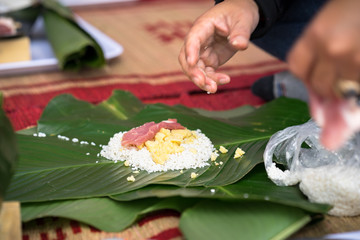 Making Chung cake by hands closeup, Chung cake is the most important traditional Vietnamese lunar New Year (Tet) food.