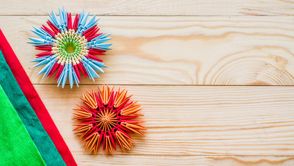modular origami flowers on rustic wooden background with paper