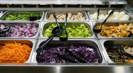 variety of colorful fresh vegetable in container in restaurant