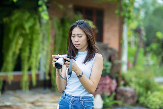 Asian girl checking photo on camera