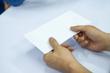 Hand businessman giving blank white envelope