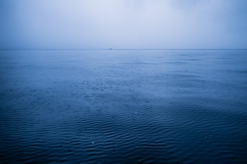 Dark blue sky and dark blue sea color and storm raining cloud background