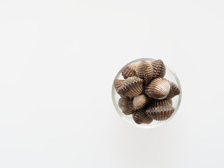 A group of raw cockle, ark shell, in a glass bowl isolated on white background