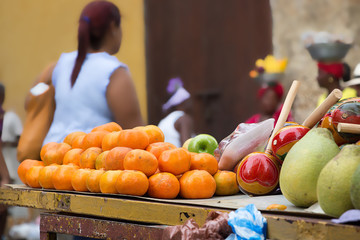 Group of oranges on a wooden cart.