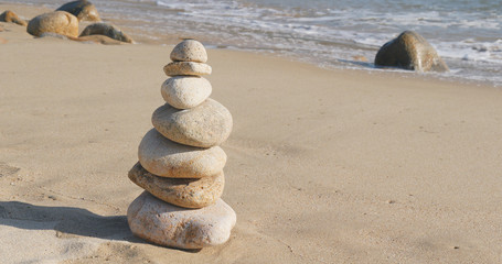 Fototapeta na wymiar Zen stones on a sand beach