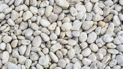 Many small stones texture and background., close up beach stone.