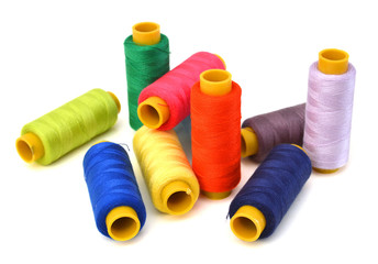 Spool of coloured thread isolated on white background.