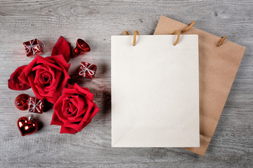 Happy Valentine's Day Concept with red roses, gift boxes, paper bag and space for text