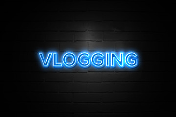 Vlogging neon Sign on brickwall