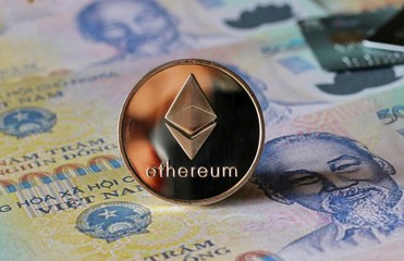 Ethereum Coin on Vietnamese Dong Banknotes Background with Credit Cards
