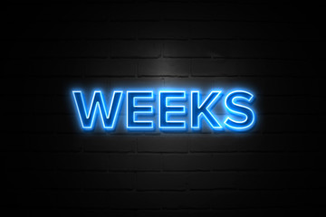 Weeks neon Sign on brickwall