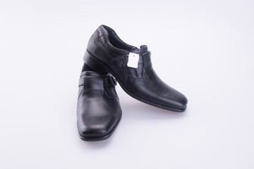 shoe or men's shoes with price tag on a background.