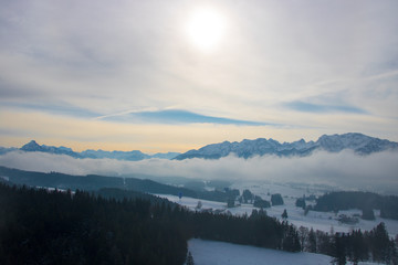 hot air balloon in winter sailing across the Alps beautiful views of mistuge snowy mountains and villages on the ground