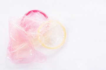 Condoms used yellow and pink, give Filing condom safe sex concept on the bed Prevent infection hiv.