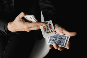 Man showing tricks with cards. magician, card tricks, card fan