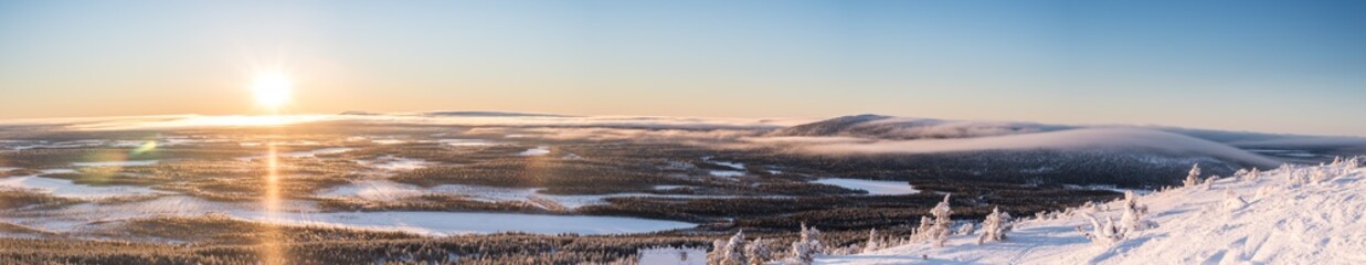 Panorama view up from the snowy mountains on a sunny winter day in Lapland Levi