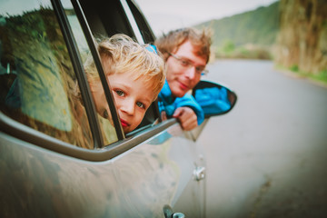 little boy with dad travel by car in nature