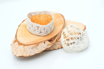 Cake in a casket in the form of heart on a section of wood