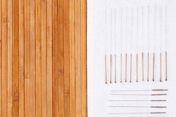 Table with needles for acupuncture. Silver needles for traditional acupuncture medicine on table.