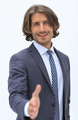 Businessman offering handshake to you on white background
