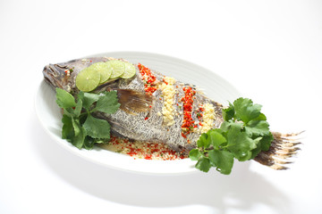 Steamed fish with spicy sauce isolated on white background