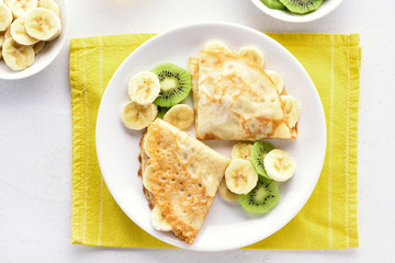 Crepes with banana and kiwi slices