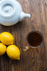 Teapot and cup of tea with lemon