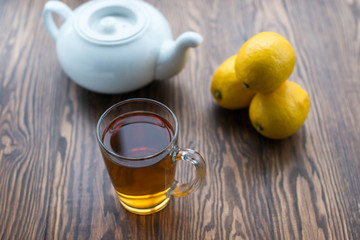 Teapot and cup of tea with lemon